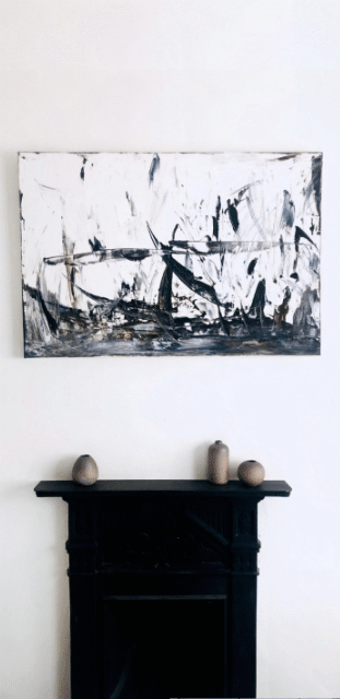 birds nest painting hanging above fireplace